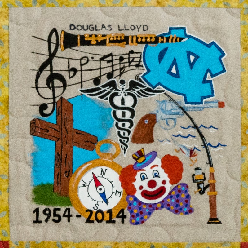 Quilt square for Douglas Lloyd with a collage of music, UNC, a cross, fishing, a clown, a compass, and a toy pistol