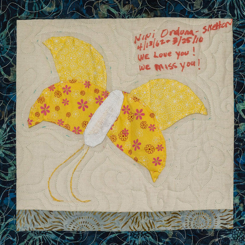 Quilt square for Jeannine Orduna-Skelton with a patch of a yellow butterfly.