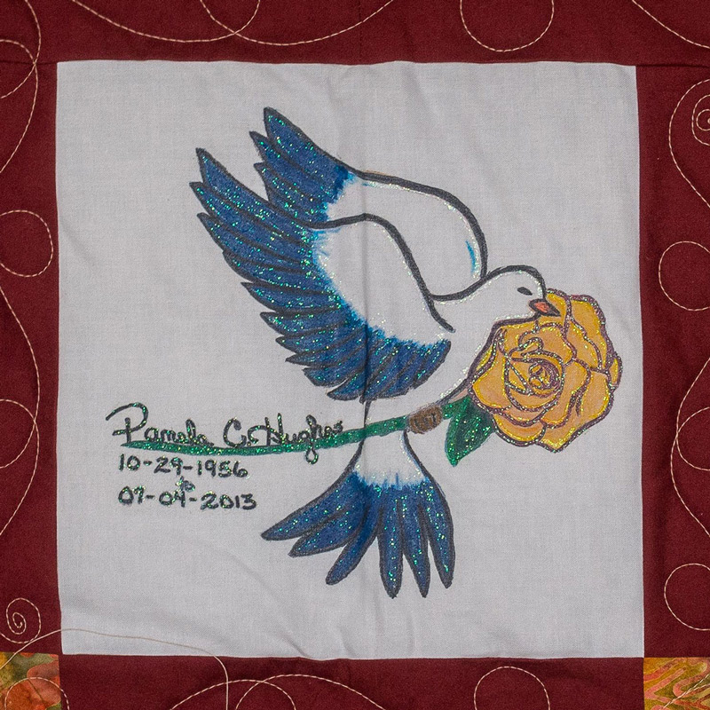 Quilt square for Pamela Hughes with a dove and a yellow rose.