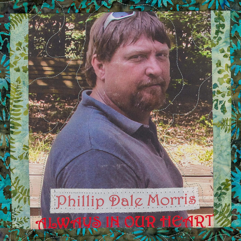 Quilt square for Phillip Dale Morris with a photo of Phillip outdoors.