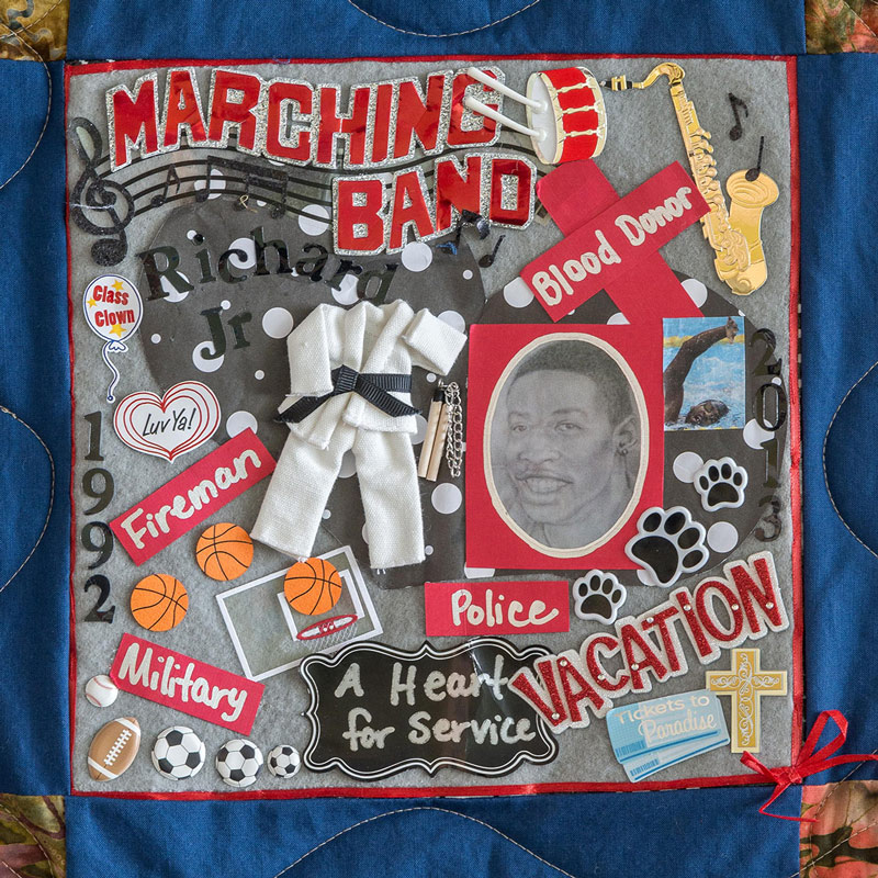 Quilt square for Richard Byers with a drawing of Richard and a collage of patches featuring saxophone, black belt, cross, tickets to paradise, basketballs, soccer balls, footballs, baseballs, music notes, and text reading: marching band, a heart for service, fireman, military, blood donor.