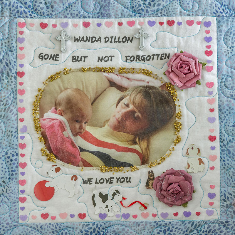 Quilt square for Wanda Dillon with photo of Wanda holding a baby.