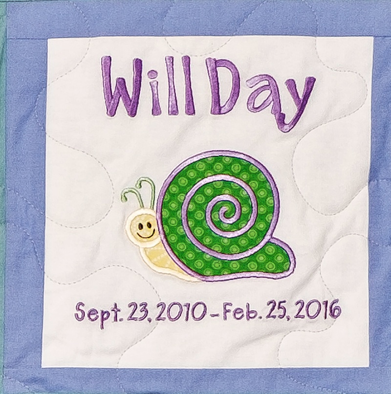 Quilt square for William Day with an illustration of a happy snail at the center
