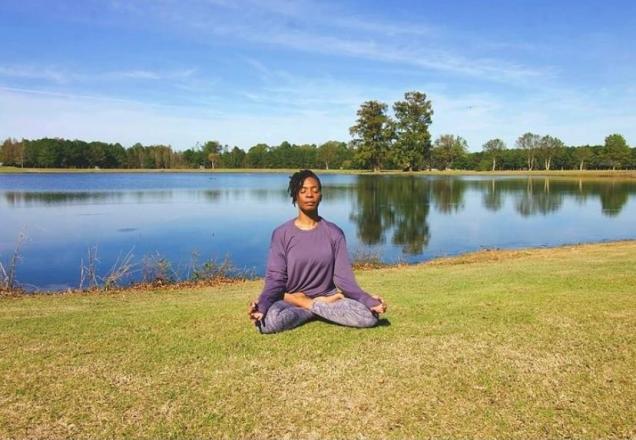 Organ recipient Phelicia relaxes on lawn by lake
