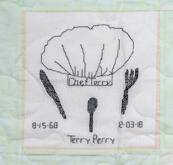 Quilt square for Terry Perry with knife, spoon, fork, and text reading: Chef Terry