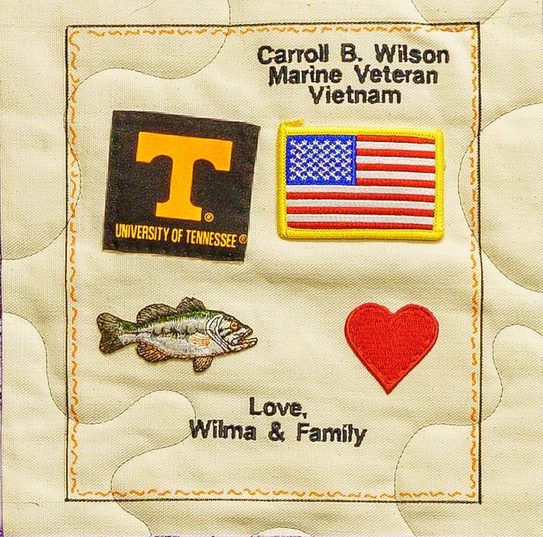Quilt square for Carroll Wilson with patches of the University of Tennessee, America Flag, Fish, heart, and text reading: love Wilma and family