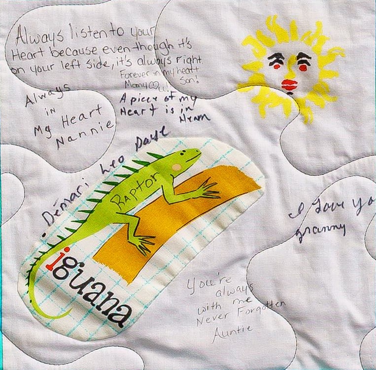 Quilt square for De'Mari Daye with handwritten messages and patches of an iguana and a son. Text reading: Always listen to your heart because even though it’s on your left side, it’s always right. Forever in my heart. Many loves. Son! Always in my heart. Nannie.