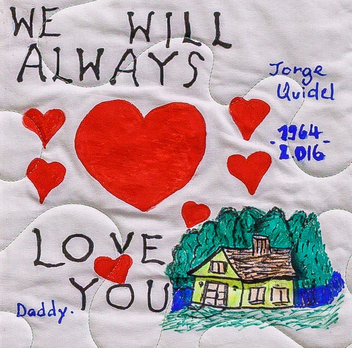 Quilt square for Jorge Quidel with hearts a house, and text reading: We will always love you.