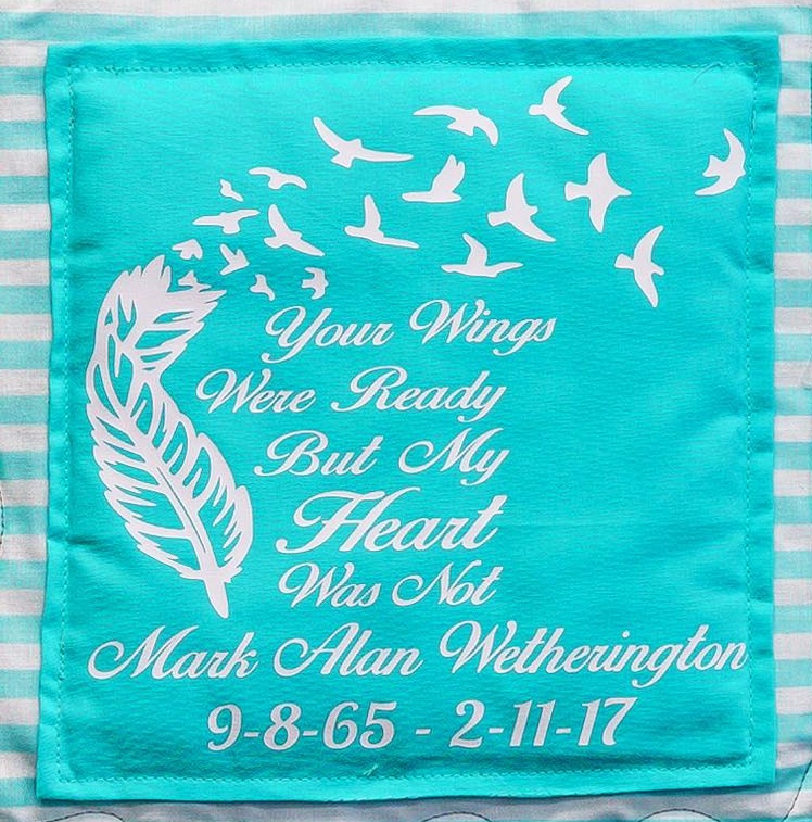 Quilt square for Mark Wetherington with a feather and birds and text reading: Your wings were ready but my heart was not