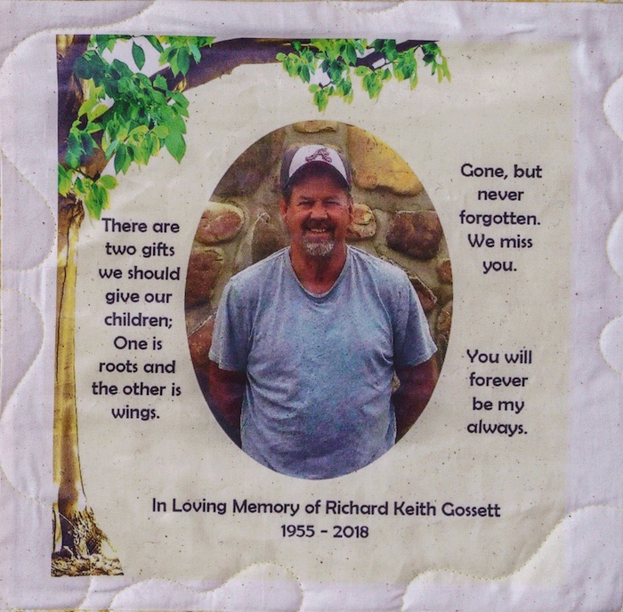 Quilt square for Richard Gossett with outdoor portrait of Richard under a patch of a tree and text reading: There are two gifts we should give our children; one is roots and the other is wings. Gone, but never forgotten. We miss you. You will forever be my always.
