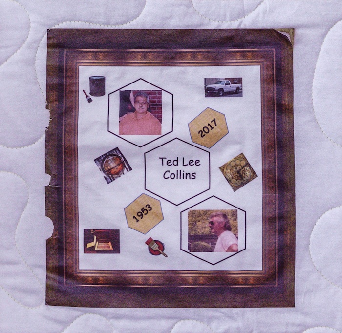 Quilt square for Ted Collins with a wood frame surrounding patches of paint, a globe, a truck, a clock, and of photos of Ted