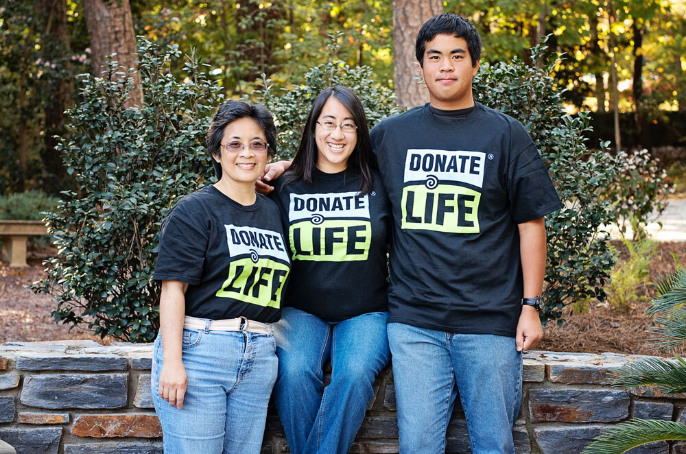 Three donate life advocates wearing donate life t-shirts pose together