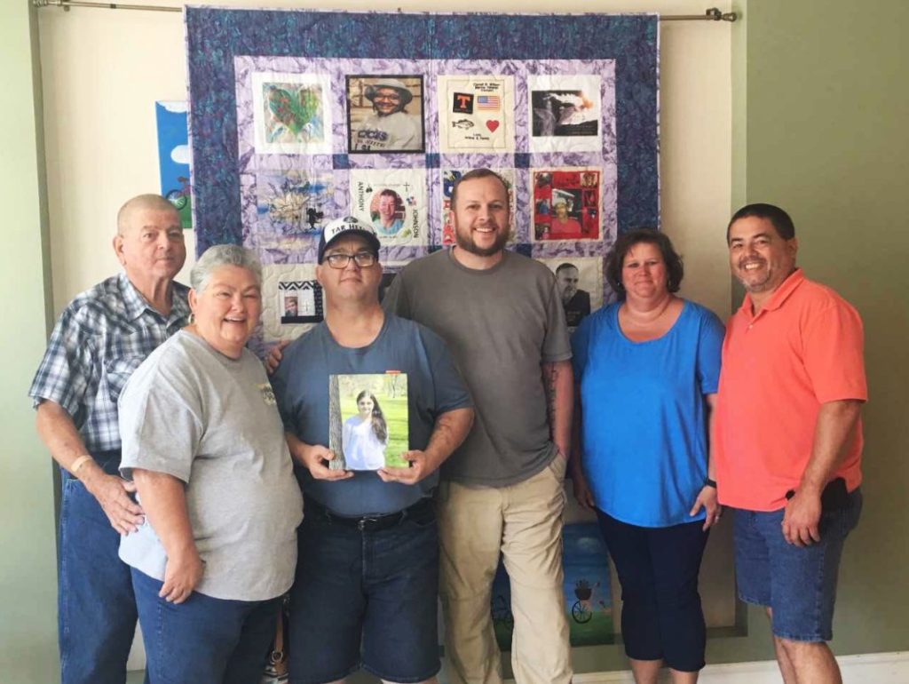 Donor Family 9 and Recipient standing in front of quilt