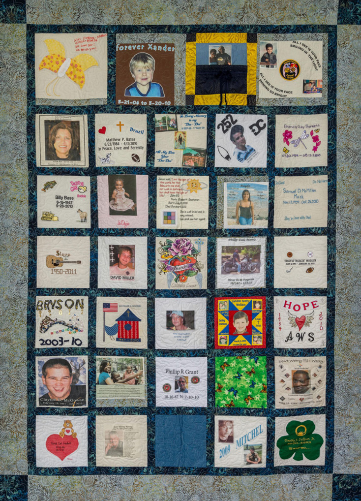 Colorful green, blue, and yellow quilt with foliage pattern and 34 unique squares featuring donor names, photos, and memories