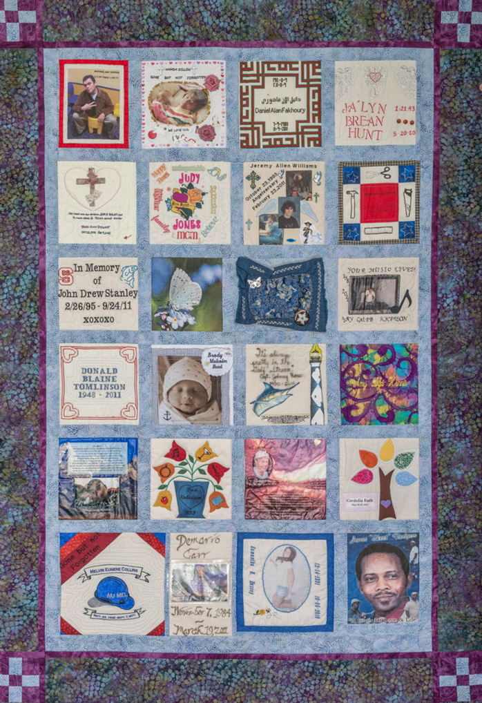 Colorful magenta and purple quilt with 24 unique squares featuring donor names, photos, and memories