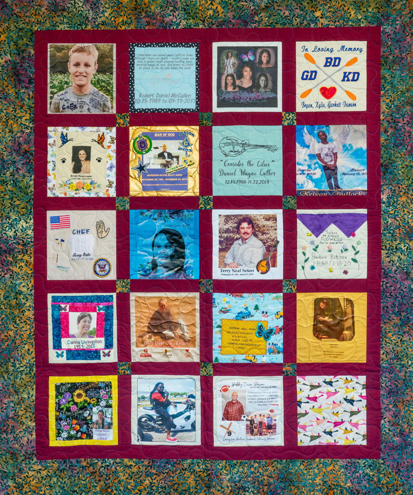 Colorful red quilt with 20 unique squares featuring donor names, photos, and memories