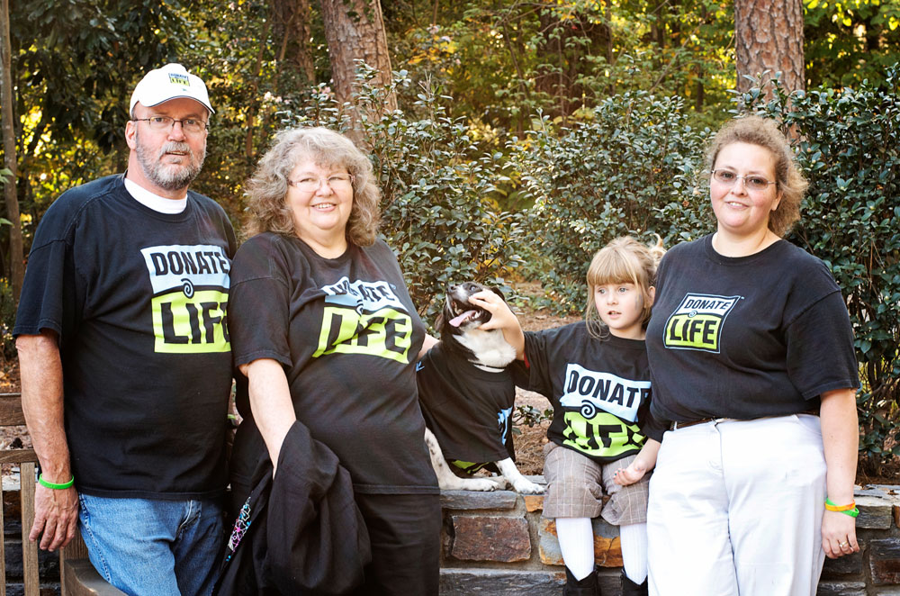 Donor family and dog wearing t-shirts with Donate Life outside
