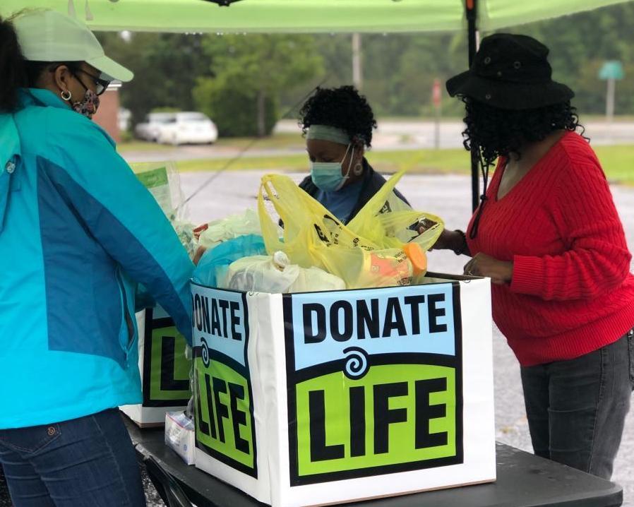 Donate life team at an outdoor event with large donate life box