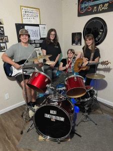 Teenagers in praise band with drums and guitars