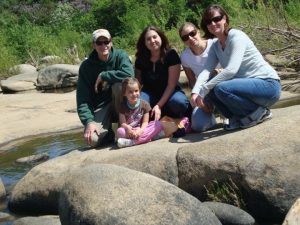 family posing on rock