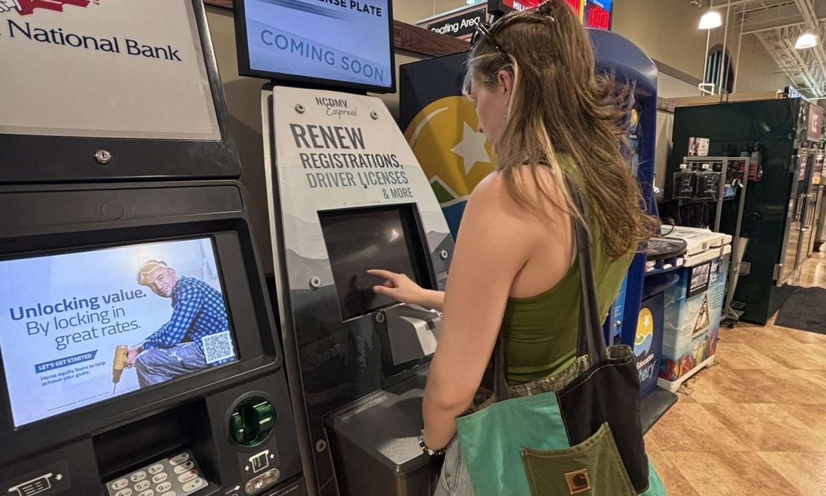 Woman stands at DVM kiosk