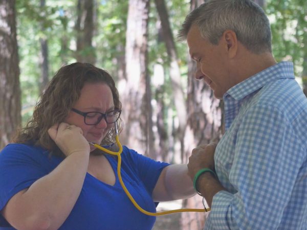 Vannessa Blais, Donor's sister, listens to her brother's heart with a stethoscope