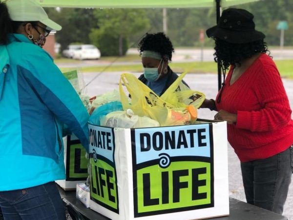 Donate life team at an outdoor event with large donate life box