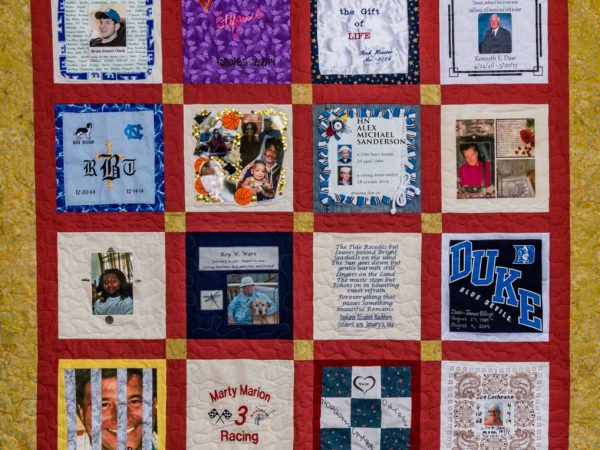 Colorful yellow and red quilt with 16 unique squares featuring donor names, photos, and memories