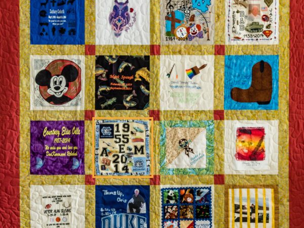 Colorful red and yellow quilt with 16 unique squares featuring donor names, photos, and memories
