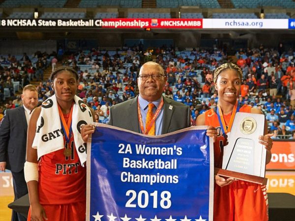 Coach Knight holding up a sign with players