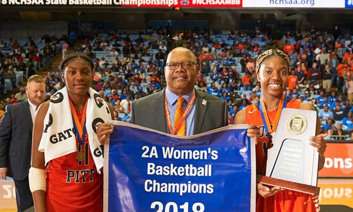 Coach Knight holding up a sign with players