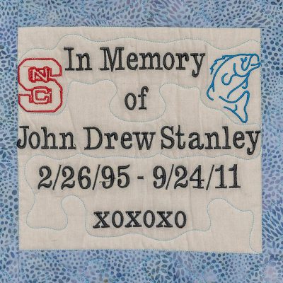 Quilt square for John Drew Stanley and a patch of the NC State Logo and a Fish