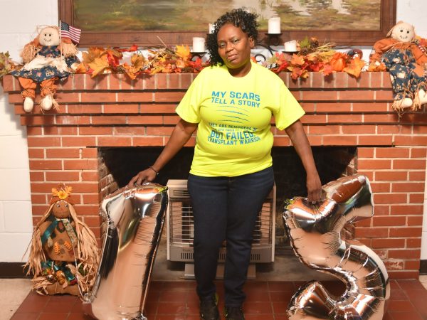African America woman posing in front of a fireplace