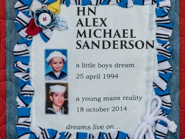 Quilt square for Alex Sanderson with photos of Alex in a sailor’s uniform as a child and as an adult sailor in the navy. Text reading: A little boys dream 25 April 1994. A young man’s reality 18 October 2014. Dreams live on
