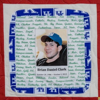 Quilt square for Brian Daniel Clark with a photo of Brian at the center surrounded by descriptive words and the University of Kentucky logo pattern.