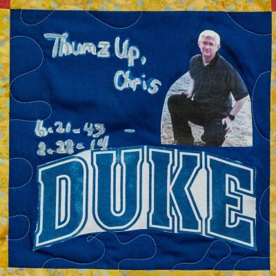 Quilt square for Chris Dunlap with a photo of Chris and the Duke logo.