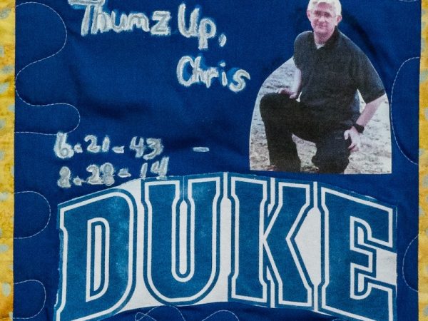 Quilt square for Chris Dunlap with a photo of Chris and the Duke logo.