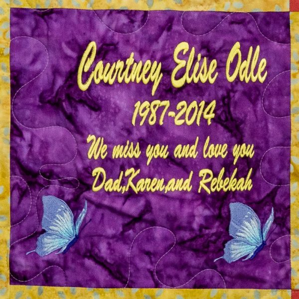 Quilt square for Courtney Odle with butterflies and text reading: We will miss you and love you. Dad, Karen, and Rebekah