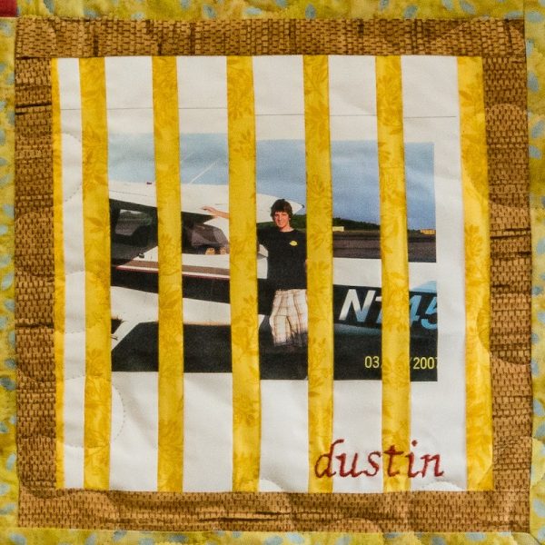 Quilt square for Dustin Simpson with a photo of Dustin standing by a plane.