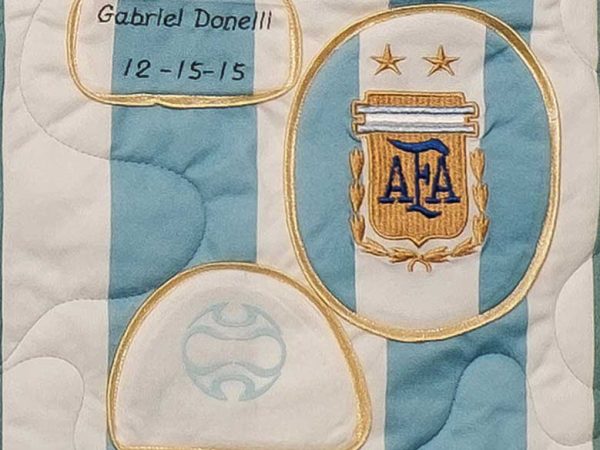 Quilt square for Gabriel Donelli with two logos, one with acronym AFA.