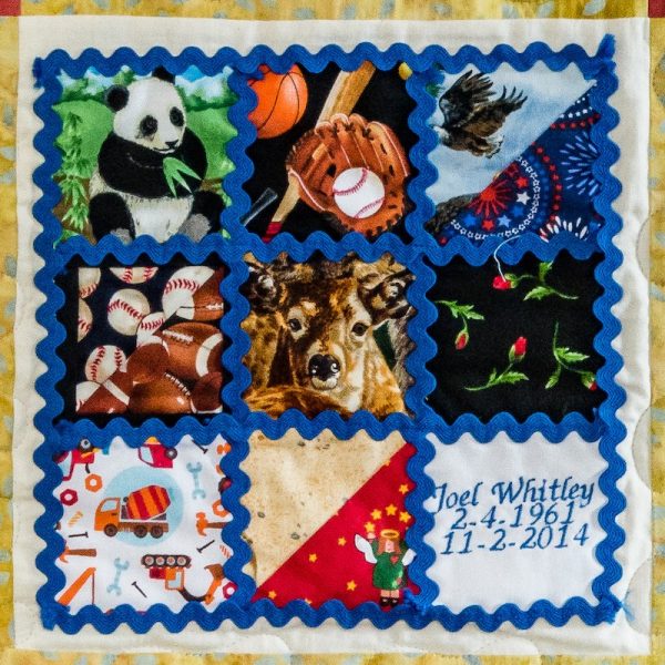 Quilt square for Joel Whitley with illustrations of a panda, baseball, the USA, sports, Deer, flowers, trucks, and angles.