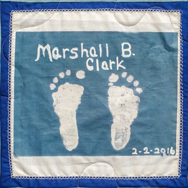 Quilt square for Marshall B. Clark with baby feet imprint.