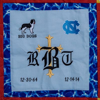 Quilt square for Roderick Bridges with patches for Big Dogs, UNC, and a cross.
