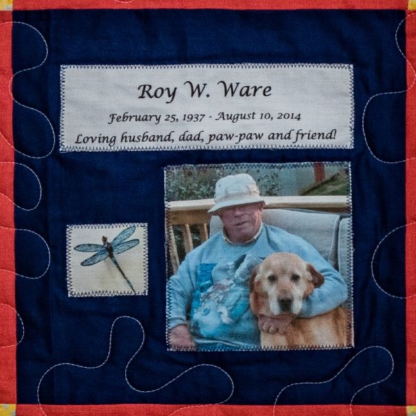 Quilt square for Roy Ware with a dragon fly and a photo of Roy with his dog. Text reading: loving husband, dad, paw-paw and friend.