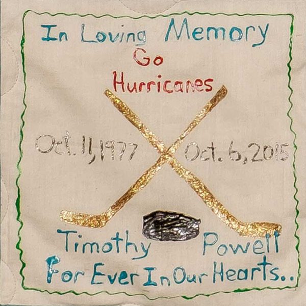 Quilt square for Timothy Powell with hockey sticks and text reading: Go Hurricanes. Forever in our hearts.