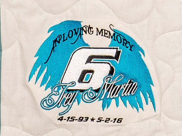 Quilt square for Trey Martin with wings around a large styled #6 and text reading: In Loving Memory.