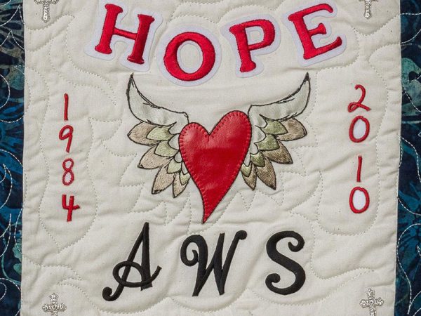 Quilt square for Andrew Smith with a heart and angle wings and text reading: Hope, AWS.
