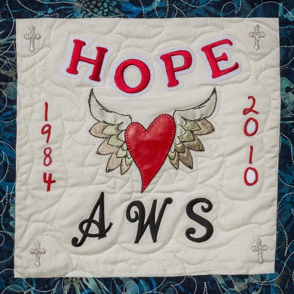 Quilt square for Andrew Smith with a heart and angle wings and text reading: Hope, AWS.