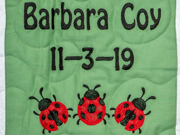 Quilt square for Barbara Coy with three lady bugs