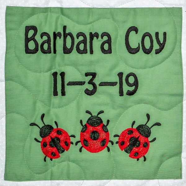 Quilt square for Barbara Coy with three lady bugs